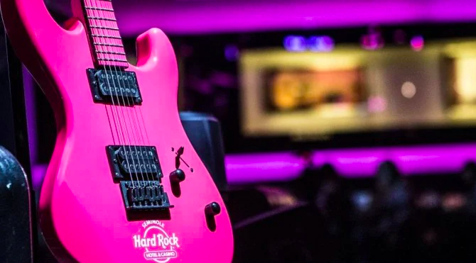 A bright pink electric guitar branded with the Hard Rock Cafe logo is displayed at Hard Rock Cafe Las Vegas as part of the venue's participation in Hard Rock International's 27th Annual PINKTOBER Campaign to raise awareness and funds for breast cancer.